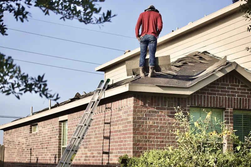 Professional roofer working on a residential roof in West Haddonfield